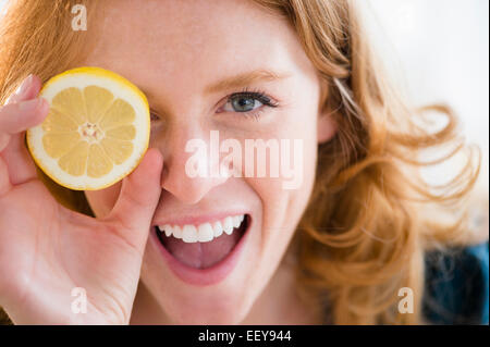Portrait of young woman holding lemon Stock Photo