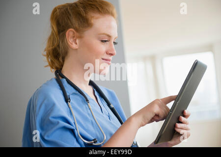 Female nurse using digital tablet Stock Photo