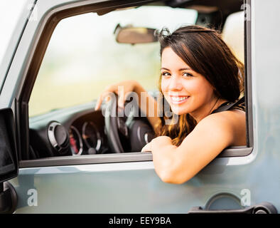 Portrait of young woman during road trip Stock Photo
