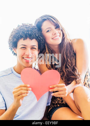 Portrait of young couple with paper heart Stock Photo