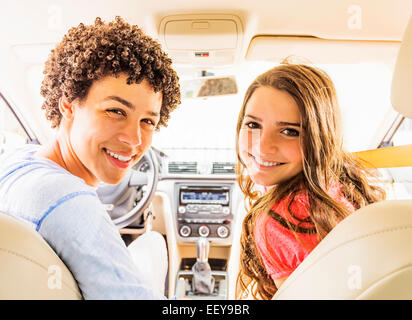 Portrait of young man and teenage girl (14-15) in car Stock Photo