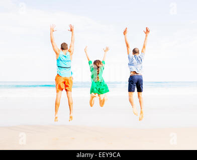 USA, Florida, Jupiter, Young people jumping on beach Stock Photo