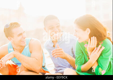 Young people talking and laughing outdoors Stock Photo
