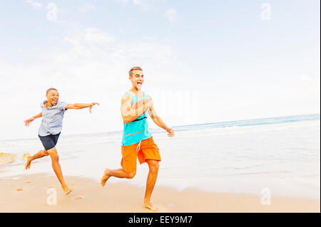 USA, Florida, Jupiter, Young men playing with football on beach Stock Photo