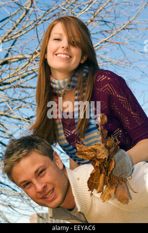 Couple in a park piggybacking Stock Photo