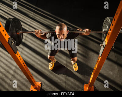 Man doing squats Stock Photo