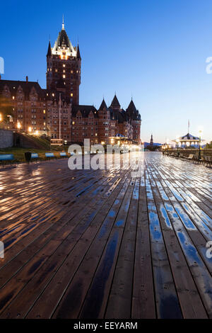 Canada, Quebec, Quebec City, Low angle view of wooden pier and illuminated   Chateau Frontenac at dawn Stock Photo