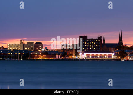 Canada, New Brunswick, Prince Edward Island, Charlottetown, Illuminated waterfront skyline against moody sky Stock Photo