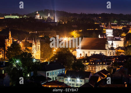 Aerial view of the illuminated Gediminas Tower and modern skyscrapers ...