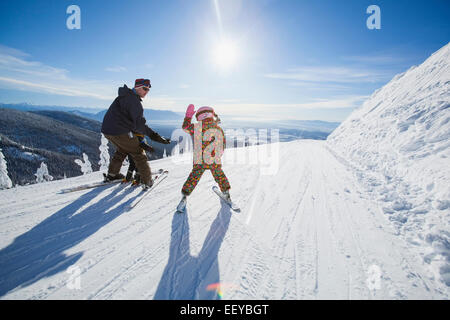 USA, Montana, Whitefish, Father skiing with children (6-7, 8-9) Stock Photo