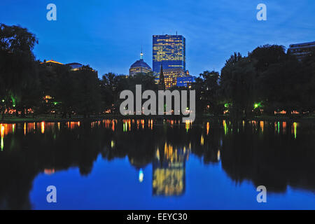 USA, Massachusetts, Boston, Skyline of Copley Square Boston reflecting in pond of Public Gardens at dusk