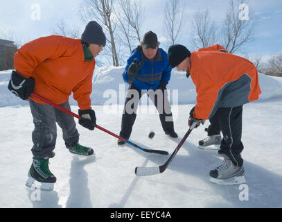 Boy ice hockey players facing off Stock Photo