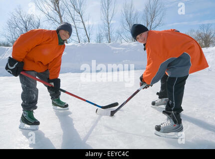 Boy ice hockey players facing off Stock Photo