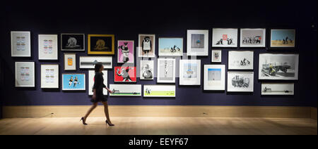 London, UK. 23 January 2015. A Bonhams employee looks at the Banksy prints from the Steve Lazarides collection. Included among the collection of iconic prints are Flower Thrower (2003), Rude Copper (2002), and Christ With Shopping Bags (2004), each estimated at £8,000-12,000. Bonhams auction house previews items from the 'Founded 1793' contemporary art auction taking place on 28 January 2015. The sale includes a collection of 30 Banksy prints owned by the English gallery owner, Steve Lazarides, and a ukulele decorated by Damien Hurst. Photo: Bettina Strenske Stock Photo