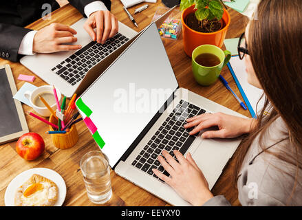 Man and woman working on laptops. Shot from above view Stock Photo