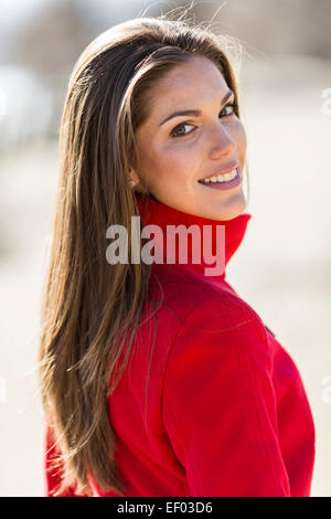 Pretty young woman in red coat Stock Photo
