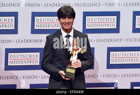 Baden-Baden, Germany. 23rd Jan, 2015. The coach of the German national soccer squad Joachim Loew smiles as he holds his award in his hands after the ceremony for the German Media Award in Baden-Baden, Germany, 23 January 2015. Loew was awarded with the German Media Award 2014. Photo: Uli Deck/dpa/Alamy Live News Stock Photo