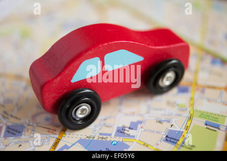 Red Wooden Toy Car On Road Map Stock Photo