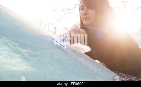 Woman Scraping Ice From Car Windshield Stock Photo