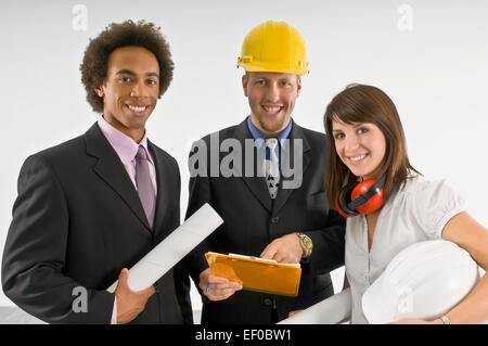 Three business people standing together Stock Photo