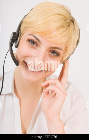 Blond woman wearing headset Stock Photo