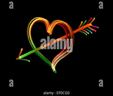Cupid's Arrow in neon light against Black Stock Photo