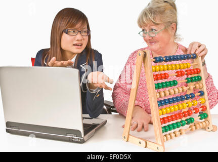 Student and teacher looking at abacus Stock Photo