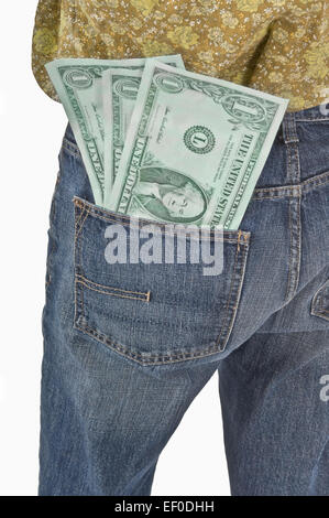 Oversized dollar bills in back pocket of jeans Stock Photo