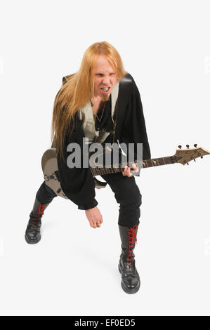 Long haired man playing guitar Stock Photo