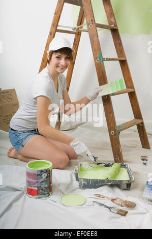 Woman painting wall Stock Photo