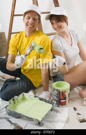 Couple preparing to paint wall Stock Photo