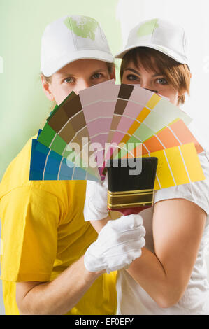 Couple holding paint swatches Stock Photo
