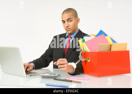 Businessman handcuffed to his work Stock Photo