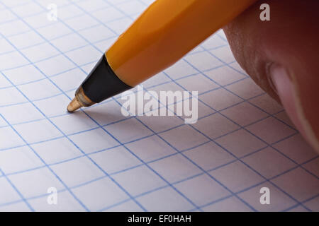 Man's hand making a pen writing in a notebook closeup Stock Photo