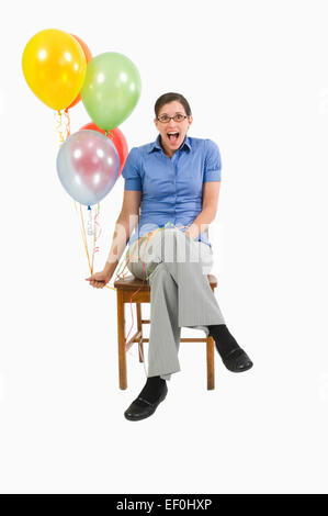 Woman holding balloons Stock Photo