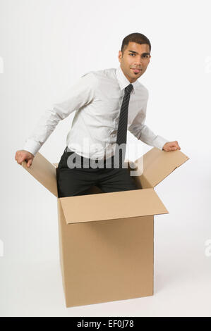 Man in a cardboard box Stock Photo
