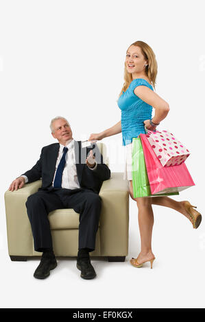 Woman handing her credit card to man Stock Photo