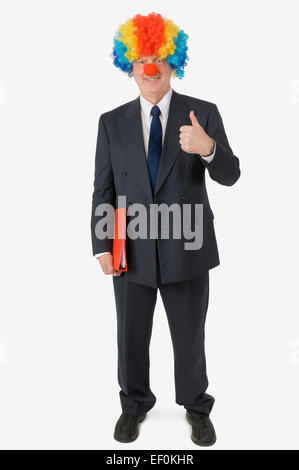 Businessman wearing clown nose and wig Stock Photo