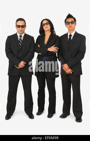 Three people dressed in black suits Stock Photo