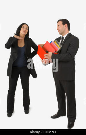 Fed up businesswoman talking to laid off businessman Stock Photo