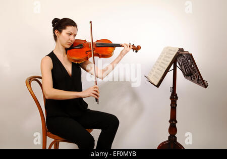 Viola player, playing her musical instrument Stock Photo