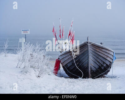 A fishing boat on shore of the Baltic Sea in winter