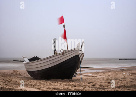 A fishing boat on shore of the Baltic Sea.