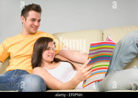 Couple relaxing on couch Stock Photo