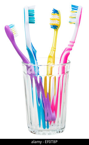 four toothbrushes in glass - family set of toothbrushes isolated on white background Stock Photo