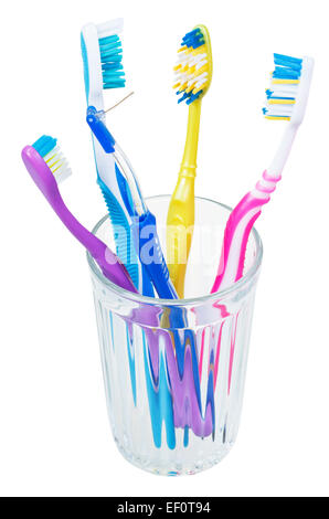 four tooth brushes and interdental brush in glass - family set of toothbrushes isolated on white background Stock Photo