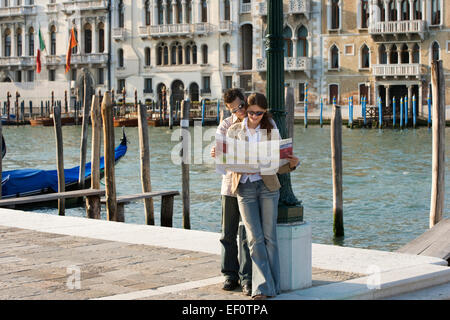 Couple looking at a map in Venice Italy