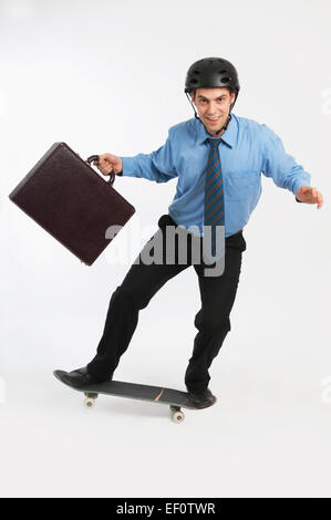 Businessman on skateboard Stock Photo