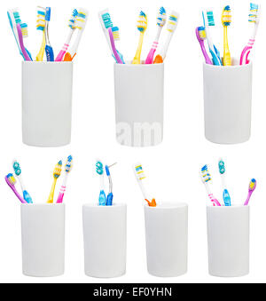 collection of tooth brushes in ceramic glases isolated on white background Stock Photo