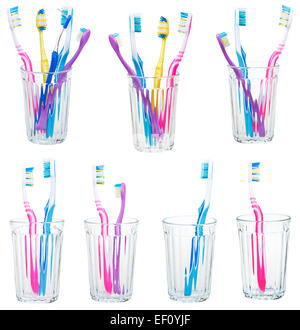 collection of tooth brushes in clear glases isolated on white background Stock Photo
